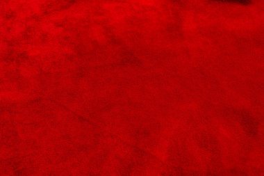 Süet kumaşın kırmızı mat arka planı, yakın plan. Pürüzsüz deri kadife desenli. Makroyu hissettim..