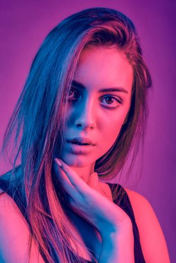 Gorgeous brunette with plump natural lips in the studio with color filters. adult