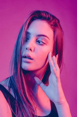 Gorgeous brunette with plump natural lips in the studio with color filters. adult