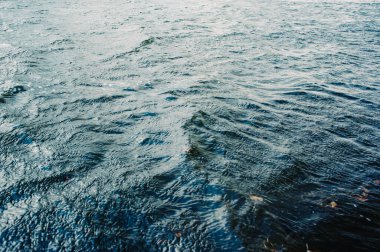 Su, göl, dalga, arka plan. Nehir suyu dokusu. Nehirdeki parlak ve yansıtıcı yüzey suyu.