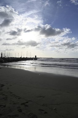 Viareggio Sahili üzerinde dramatik bir gökyüzü. Viareggio, Toskana, İtalya. Sahil ve liman iskelesi. Mavi gökyüzünde bazı bulutlar.