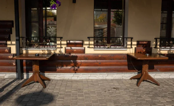 Wooden tables in a street cafe on a clear Sunny day.