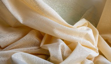 Bej tül kumaş arka plan, dikişsiz doku, güzel yakın plan ve zarif kumaş arka plan ayrıntıları. Yumuşak vintage kumaşlı lüks tül tekstil deseni.