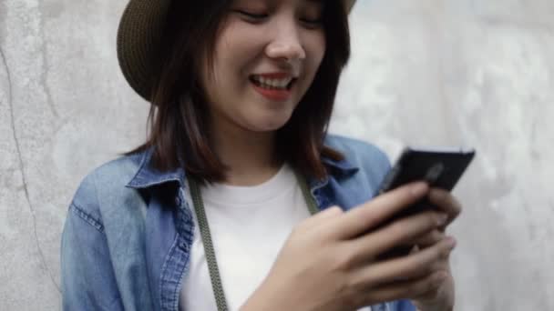 Smiling Asian Woman Wearing Retro Fedora Hat Using Smartphone Typing — Stock Video