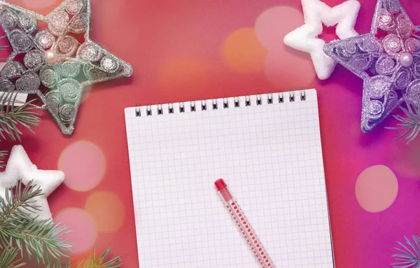 Christmas wish list, notepad on red background, to-do list, holiday mood with bokeh