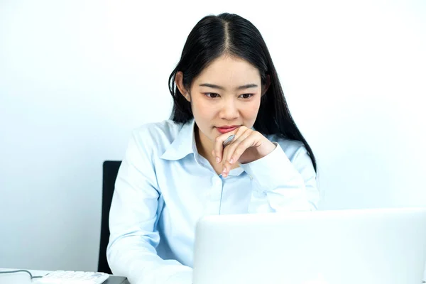 Working Asian women feel stressed, dismal tired from work, migraine headaches from hard work while working at the office.