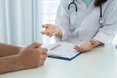 Kadın doktorlar, erkek bir hasta bir doktorla tanışıp hastalık sorunlarıyla ilgili sonuçlar aldıktan sonra tedavi önerirler. Tıbbi ve sağlık hizmetleri kavramları.