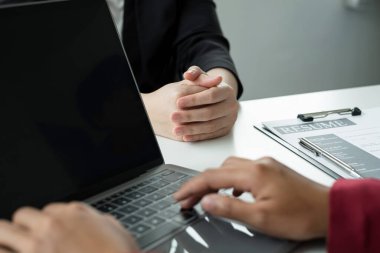 Business people hold a resume and talk to work applicants for work interviews about careers and Their personal history in the company. Recruitment concepts.