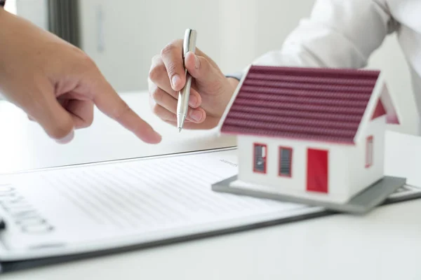 Real estate agents offer sale home insurance and close the sale immediately after the customer signs a purchase contract under a formal agreement. Real estate Home insurance concept.
