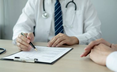 Erkek doktorlar, bir kadın hasta bir doktorla tanışıp hastalık sorunlarıyla ilgili sonuçlar aldıktan sonra tedavi öneriyor. Tıbbi ve sağlık hizmetleri kavramları.