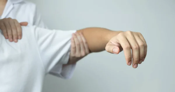 Female physiotherapists provide physical assistance to male patients with shoulder injuries massage their shoulders for muscle recovery in the rehabilitation center. Physiotherapy concepts.