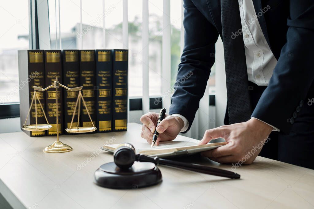 Professional man lawyers work at a law office There are scales, Scales of justice, judges gavel, and litigation documents. Concepts of law and justice.