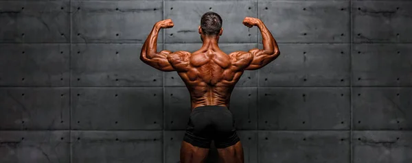 Bodybuilder Flexing Muscles Back Copy Space — Stock Photo, Image