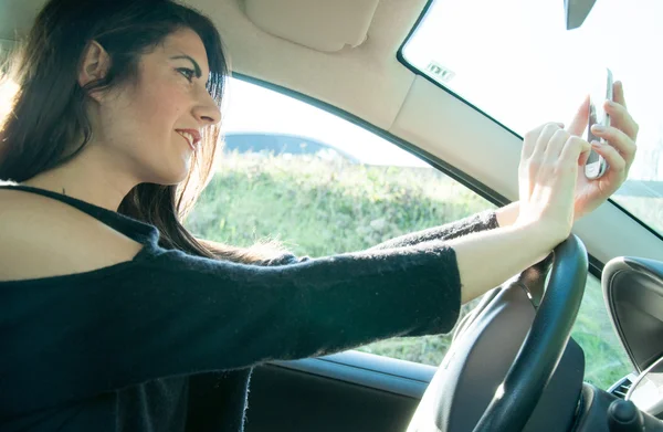 Female driver with his smart phone — Stock Photo, Image