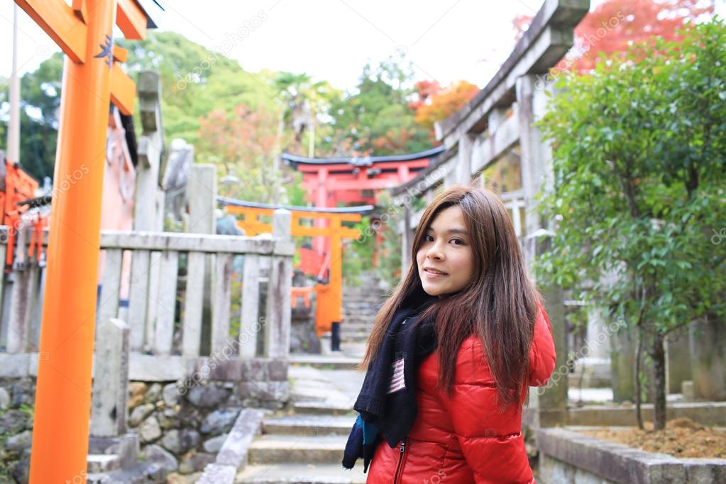 Girl look back when she travel the toril in shrine in japan