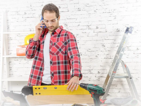 Young worker phone, in his studio — Stock Photo, Image