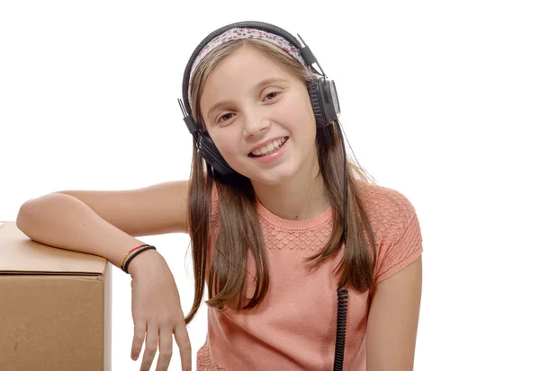 Preteen listening to music with headphones on white — Stock Photo, Image