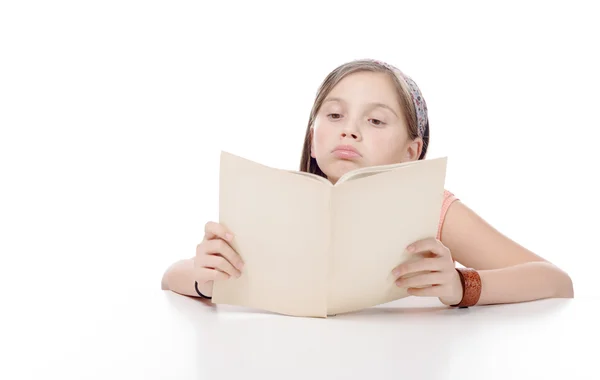 Preteen girl reads a book, on white — Stock Photo, Image