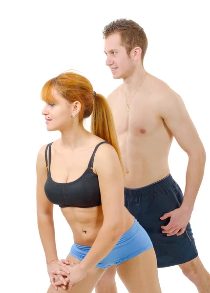 Beautiful young woman and man doing stretching exercises Stock Photo