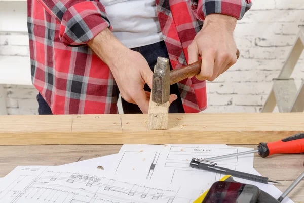 Carpenter hammer a nail — Stock Photo, Image