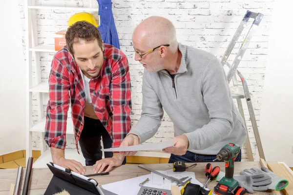 Two technicians read plan in the workshop — Stock Photo, Image