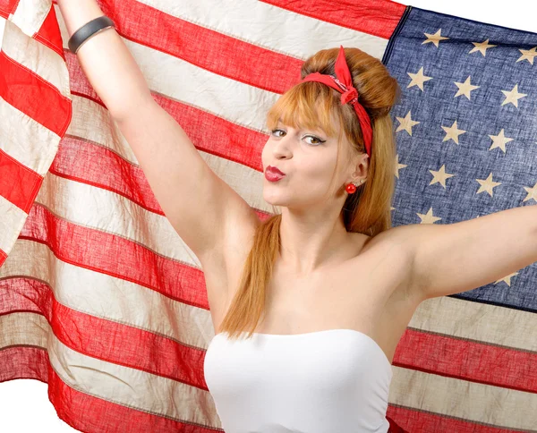 Sexy pin-up girl houden van een Amerikaanse vlag. Stockfoto