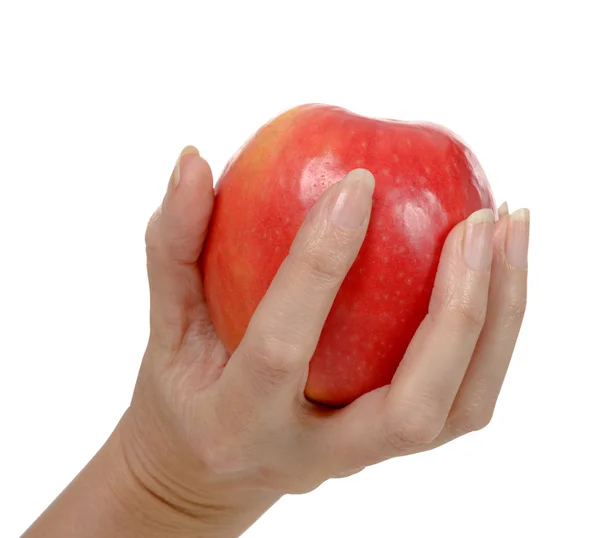 Die Hand einer Frau hält einen roten Apfel. — Stockfoto