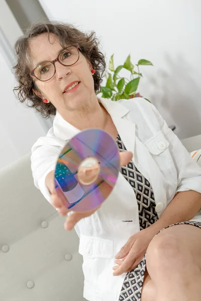 Mature woman with a compact disc — Stock Photo, Image