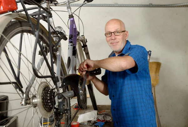 Man repareren fiets in zijn atelier. — Stockfoto