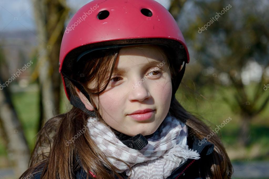 Teenage girl wearing a roller skate helmet. Stock Photo by ©philipimage