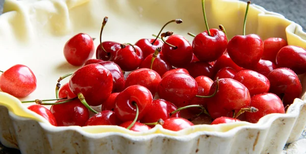 Fresh cherries and pie dough — Stock Photo, Image