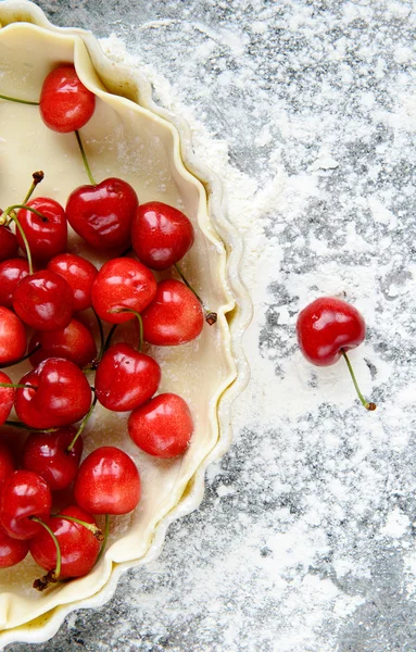 Fresh cherries and pie dough — Stock Photo, Image