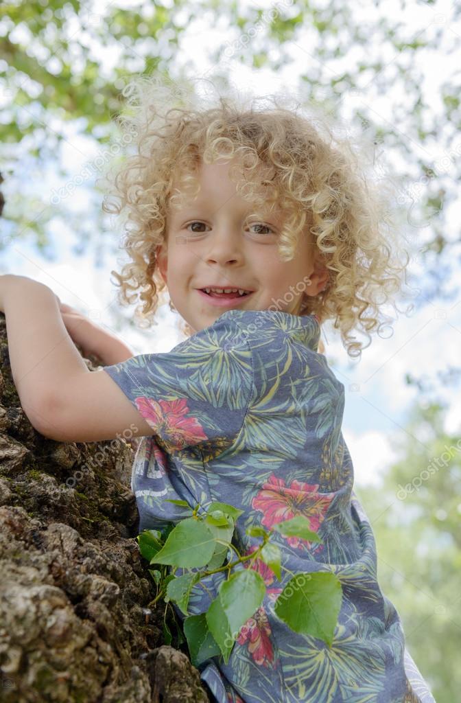 Portrait Of A Young Boy With Blond Curly Hair Stock Photo