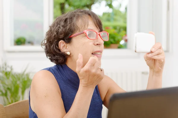 Retrato de una mujer madura con un teléfono —  Fotos de Stock