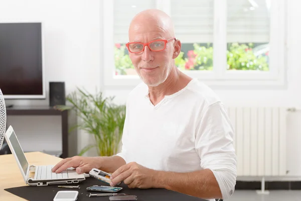 Mature man repaired a smartphone — Stock Photo, Image