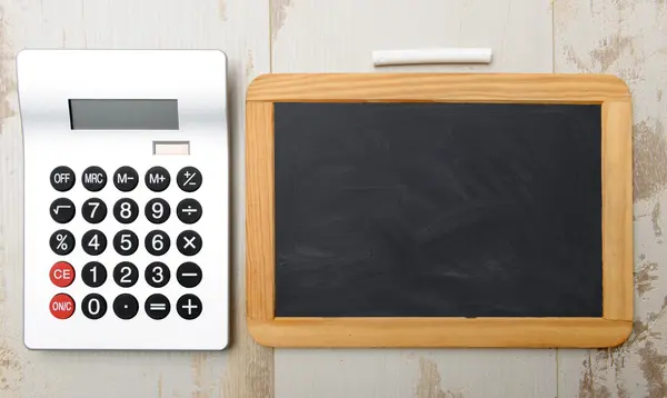 Chalkboard and calculator — Stock Photo, Image