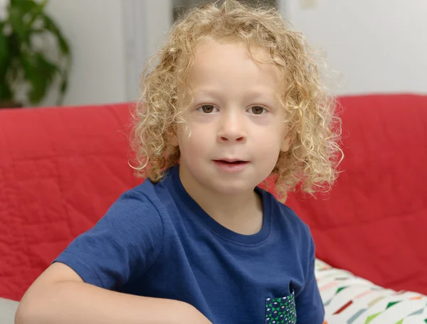Portrait of a little boy with blond curly hair — Stock Photo, Image