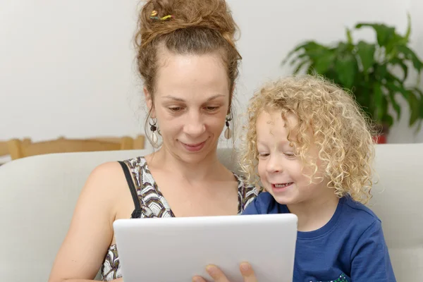 Blond little boy and his mom with a digital tablet — Stock Photo, Image