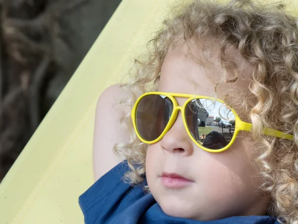 Little blond boy and yellow sunglasses — Stock Photo, Image