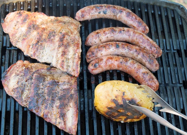 Costela de carne com batatas no churrasco — Fotografia de Stock