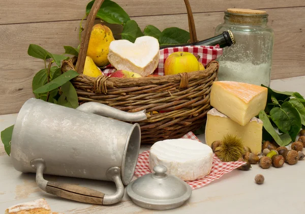 Γαλλικά τυριά με ένα καλάθι με μήλα — Φωτογραφία Αρχείου
