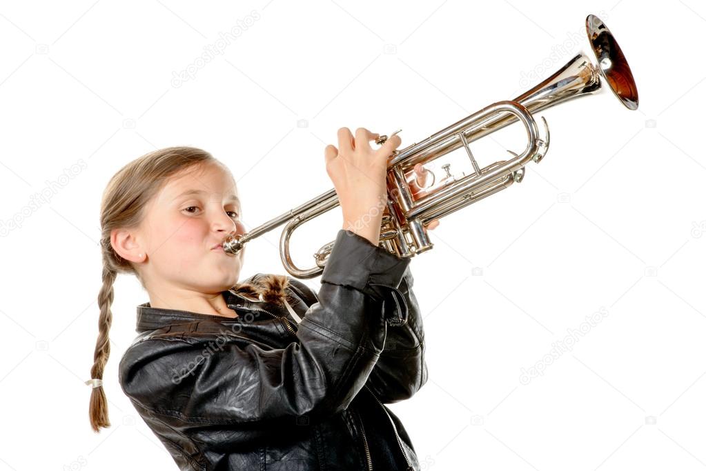 a pretty little girl with a black jacket plays the trumpet
