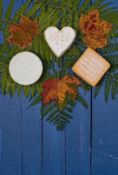 Different french cheeses on blue wooden table — Stock Photo, Image