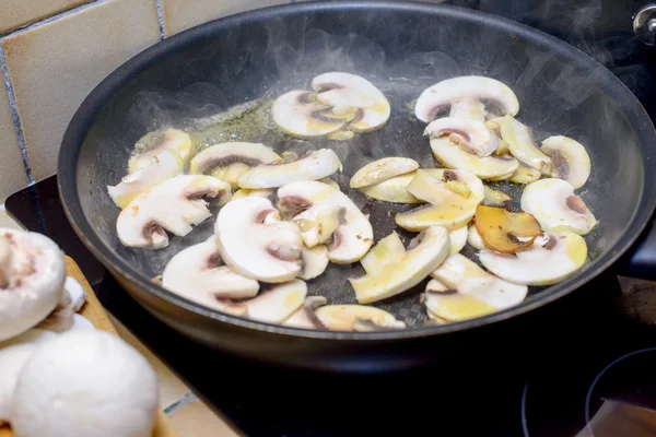 Cooking the mushrooms in a skillet — Stock Photo, Image