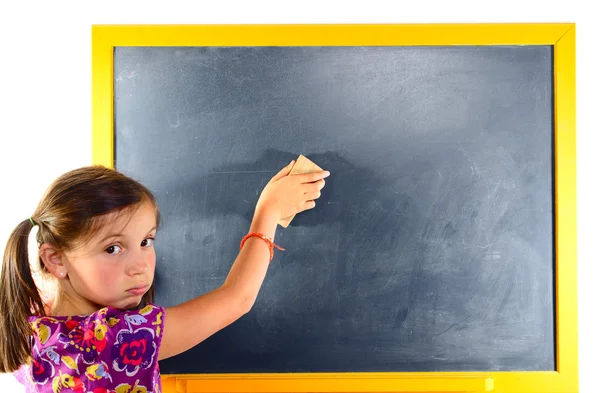 A young schoolgirl erase the blackboard — Stock Photo, Image