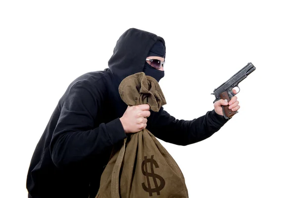 Kukuletalı soyguncu bir silah ve bir çanta dolusu para ile — Stok fotoğraf