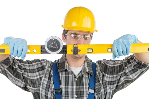 A young worker with a level — Stock Photo, Image