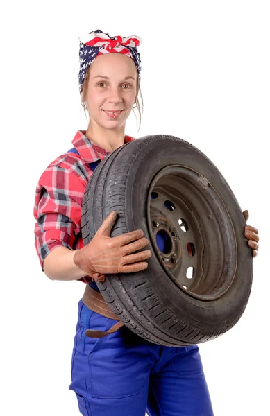 Young woman mechanic with a car wheel — Stock Photo, Image