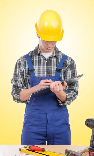 A young worker with a tablet in his office — Stock Photo, Image