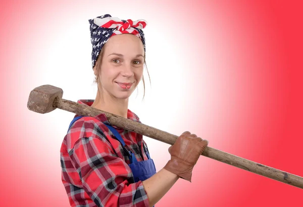 A pretty young working woman with a sledgehammer — Stock Photo, Image